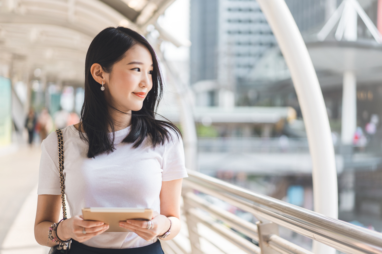Young adult business working asian woman interactive digital tablet for corporate with team via online.