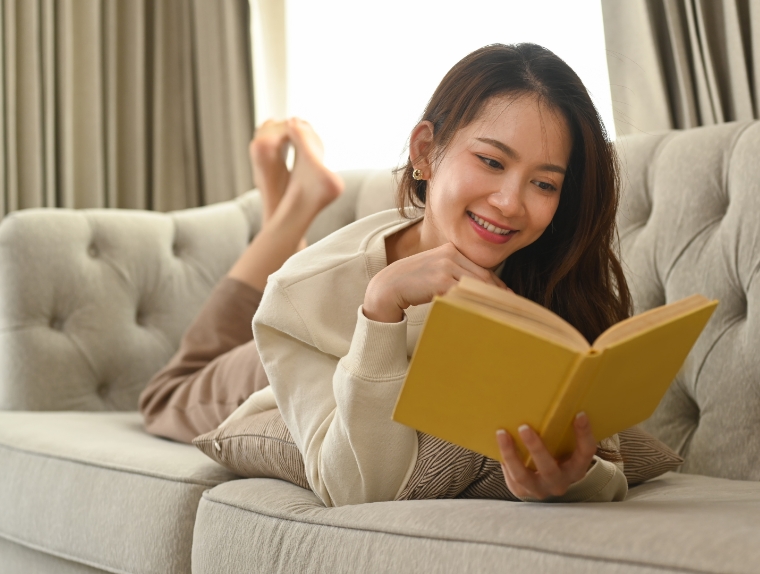 peaceful-young-woman-resting-on-couch